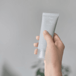 Hand holding Celimax Dual Barrier Watery Sun Cream SPF50+ PA++++ hydrating facial sunscreen
