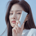 Model holding Celimax Dual Barrier Watery Sun Cream SPF50+ PA++++ Korean skincare sunscreen