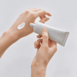 Applying Celimax Dual Barrier Watery Sun Cream SPF50+ PA++++ showing lightweight moisturizing texture