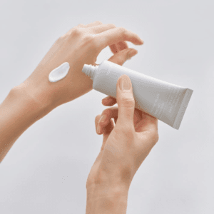 Applying Celimax Dual Barrier Watery Sun Cream SPF50+ PA++++ showing lightweight moisturizing texture